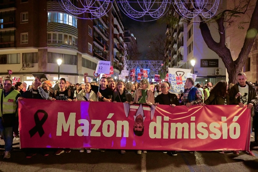 La gente lleva una pancarta pidiendo la dimisión del presidente regional de Valencia, Carlos Mazon, durante una manifestación para protestar por la respuesta del gobierno regional a las devastadoras inundaciones de hace un mes en Valencia, este de España, el 30 de noviembre de 2024. Foto Afp